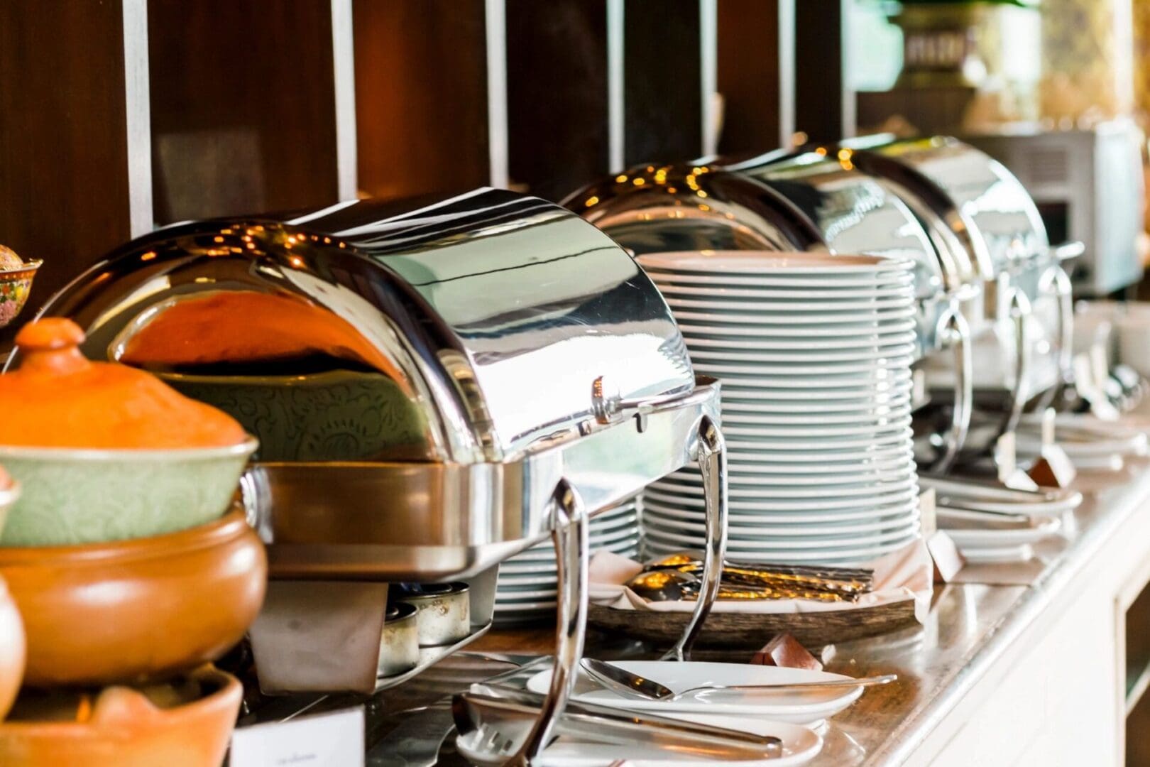 A row of metal trays and dishes on top of a counter.